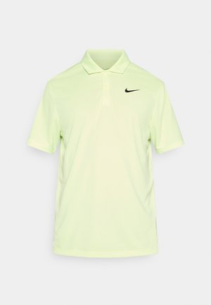Polo vert clair en tissu respirant, avec un logo Nike noir sur la poitrine gauche, col classique et manches courtes.