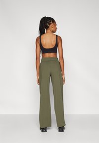 Under Armour MOTION OPEN PANT - Jogginghose - marine green/black