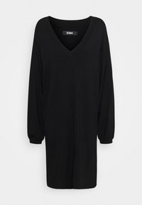 Svart oversized klänning med V-ringning, långa puffärmar och rak nederkant. Tillverkad av ett mjukt, texturerat tyg. Varumärkesetikett synlig.