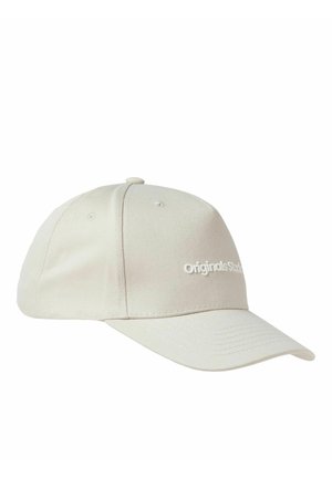 Beige cap made of soft fabric, featuring a curved brim and embroidered "originals studio" logo on the front. Classic five-panel design.