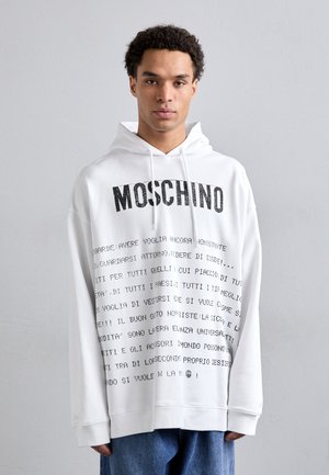 Weiße Kapuzenjacke mit einem Vorderdruck in Schwarz. Verfügt über eine Kordelzugkapuze und eine lockere Passform. Hergestellt aus weichem, strukturiertem Stoff.