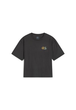 Camiseta negra de manga corta con un pequeño gráfico de sol amarillo y texto "Off the Wall" en el pecho izquierdo.