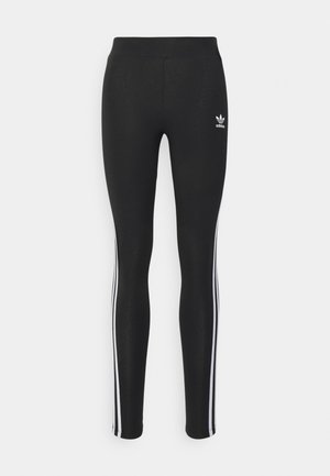 Leggings neri con una texture liscia, caratterizzati da tre strisce laterali bianche e un piccolo logo Adidas bianco sulla vita anteriore.