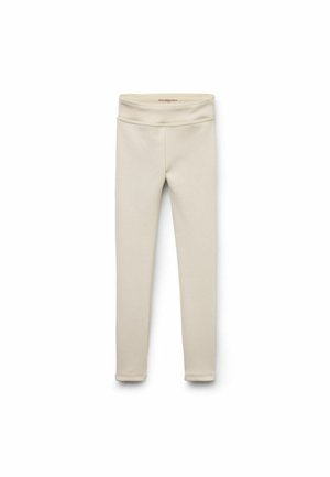 Leggings beiges en matière douce et extensible. Dotés d'une taille large et d'un design lisse sans couture pour plus de confort.