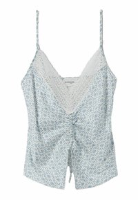 Camiseta blanca con estampado floral azul, escote en V con encaje, parte delantera fruncida y tirantes finos ajustables.