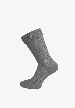 Grey knitted wool sock with a folded cuff and a small metal spider pin attached near the top.
