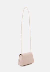 Compact pink handbag with a soft texture, featuring a gold chain strap and a structured shape, designed for crossbody wear.