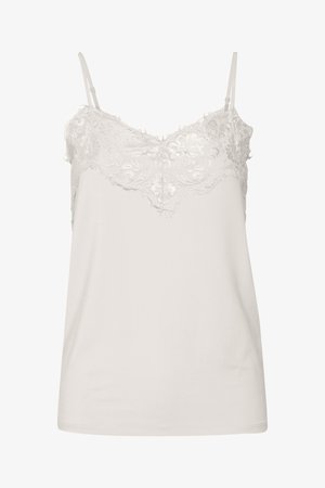 Kergelt kreemjas pitsiga pehme top, millel on reguleeritavad rihmad, skaalapitsist overlay, mis katab keha, ning sile materjal õrnate tekstuuridega.