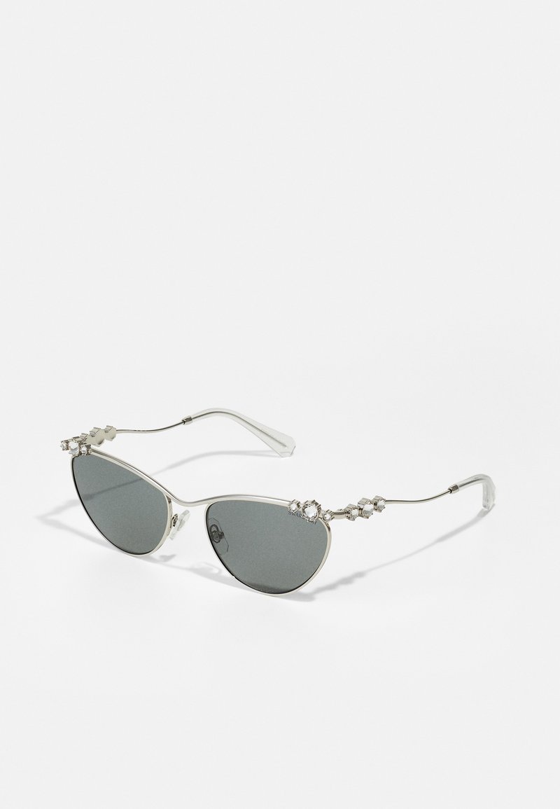 Cat-eye sunglasses with gray tinted lenses, silver metal frame, and decorative stones on the arms. Features sleek design with thin temples.