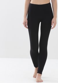 Zwarte leggings van rekbaar materiaal, met een nauwsluitend ontwerp dat zich aan de benen vormt, met een gladde textuur en geen zichtbare patronen.