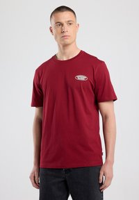 Red cotton t-shirt with a crew neck, short sleeves, and a circular white logo reading "ESPRESSO RECORDS" on the left chest.
