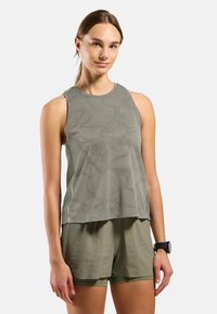 Sleeveless athletic top in muted green; features a textured pattern and subtle logo; paired with matching lightweight shorts.