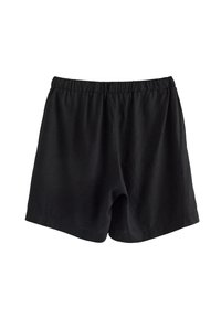 Black elastic waist shorts with a loose fit and no visible pockets, displayed on a white background.
