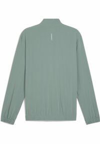 Lichtgroene lange mouw jack met een hoge kraag, elastische manchetten en tailleband, voorzien van een klein reflecterend logo op de bovenrug.