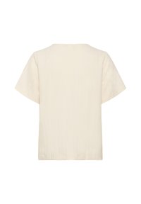 Chemise à manches courtes de couleur crème avec une coupe décontractée ; présente un tissu texturé et un col rond. Le dos est uni.