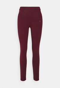 Leggings burdeos con una textura suave y elástica, de cintura alta, y un logo sutil impreso en el lado inferior. Diseño clásico y ajustado.