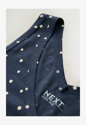 Tmavě modré šaty bez rukávů s bílými puntíky a viditelnou etiketou NEXT uvnitř u švu u výstřihu.