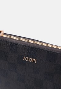 Navy textured leather pouch with gold-tone zipper and logo, featuring a checkered pattern on one side and a smooth finish on the other.