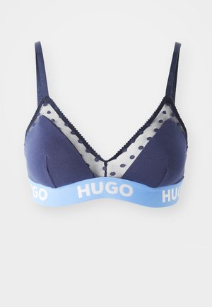 Navy blue bralette with polka dot mesh insets, adjustable straps, embroidered edging, and a light blue elastic band featuring "HUGO" logo.