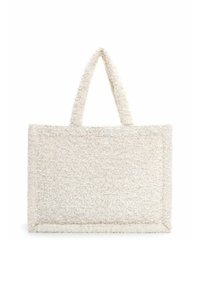 Suorakaiteen muotoinen valkoinen pörröinen kangaskassi, jossa on kaksi lyhyttä kahvaa, teksturoitu pinta ja neliömäiset reunat, valkoista taustaa vasten.