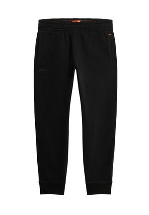 Pantalones de chándal negros hechos de tela suave, con una cintura elástica, dobladillos ajustados y bolsillos laterales. Acento naranja notable en la cintura.
