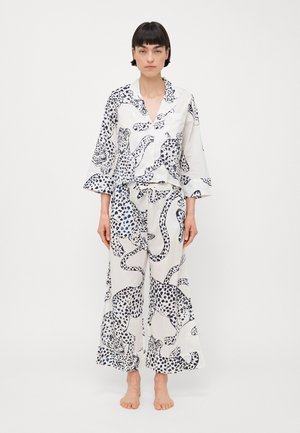 Cotton pajama set featuring a white background with blue leopard print. The top has a collar and bell sleeves; pants are wide-legged.