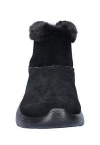 Zwarte enkellaars gemaakt van suede met een neppelzen kraag. Heeft een ronde neus en een zwarte rubberen zool met een gestructureerde grip.