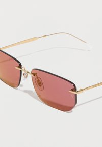 Γυαλιά ηλίου ορθογώνια με χρυστά μεταλλικά πλαίσια και φακούς με κοκκινωπή καφέ απόχρωση σε λευκό φόντο.