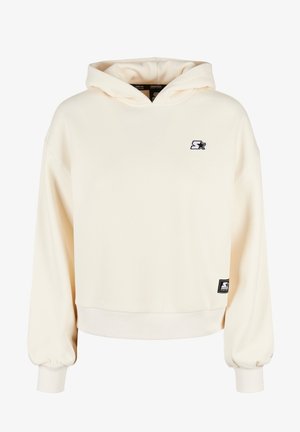 Kremkrāsas kapuce svārki, izgatavoti no mīksta materiāla. Ievērojami ribota apkakle un apakša, kā arī mazs izšūts logs uz krūtīm.