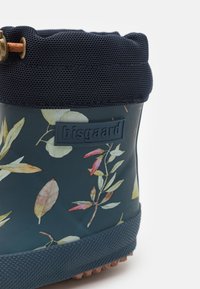 Ciemnoniebieski wodoodporny but z kwiatowymi wzorami, teksturowaną gumową podeszwą, siateczkową mankietą i niebieską etykietą z logo po bokach.