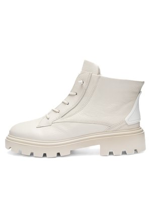 White leather ankle boot with chunky treaded sole, front laces, and padded collar, shown from the outer side on a white background.