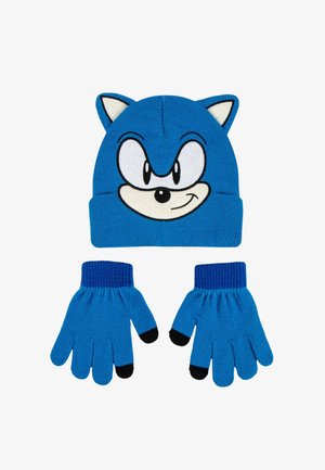 Blauwe gebreide muts met een cartoongezicht en oren die lijken op een egel, gecombineerd met bijpassende blauwe handschoenen met donkere vingertoppen.