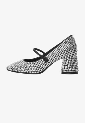 Talons Mary Jane noirs couverts de strass argentés espacés uniformément, avec un talon bloc et une bride unique sur le cou-de-pied.