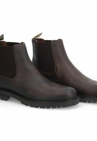 Bottes Chelsea en cuir marron avec des panneaux latéraux élastiques, bout rond et semelle en caoutchouc texturée. Tirant au talon pour un enfilage facile.