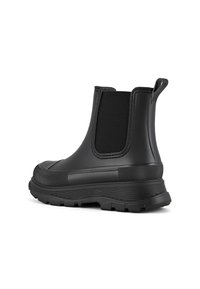Černé gumové Chelsea boty s elastickými bočními panely, kulatou špičkou, texturovanými akcenty a silnou, robustní podrážkou pro lepší přilnavost.
