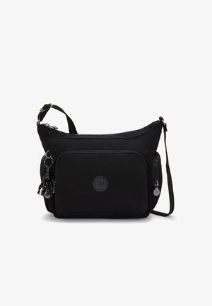 Black nylon crossbody bag with a zip closure, front pocket, and a circular logo. Features a detachable charm and adjustable shoulder strap.