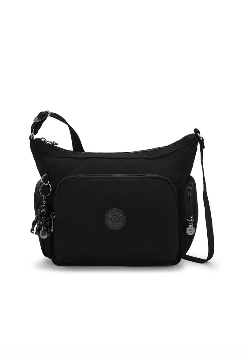 Borsa a tracolla nera in nylon con chiusura a zip, tasca frontale e logo circolare. Presenta un charm removibile e una tracolla regolabile.