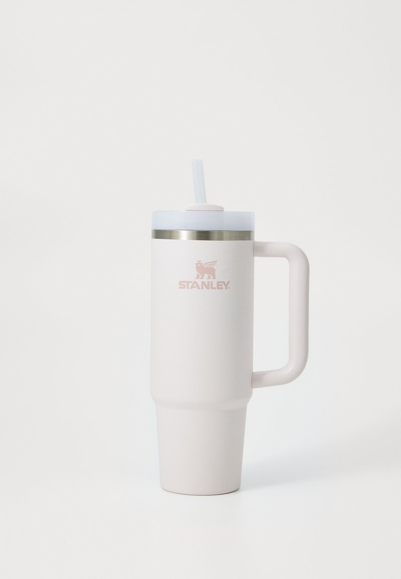 Light pink insulated tumbler with a textured finish, stainless steel band near the top, and a matching lid with a straw. Features a handle.