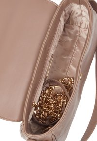 Pink leather handbag with a smooth exterior, gold chain inside, and a satin-lined interior featuring a subtle pattern.