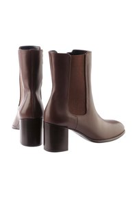 Brown leather ankle boots with a sleek design, elastic panels, and a block heel. Smooth texture with contrasting fabric accents on the sides.