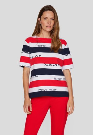 Striped short-sleeve top featuring red, white, and navy alternating bands with text elements, made from a textured fabric.