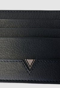 Portafoglio in pelle nera con molteplici scomparti per carte, caratterizzato da una superficie texturizzata e un accento triangolare argentato. Dettagli di cucitura visibili.