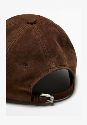 Casquette en suédine marron avec une couronne arrondie, un bouton en haut, des coutures surpiquées et une sangle réglable en métal argenté à l'arrière.