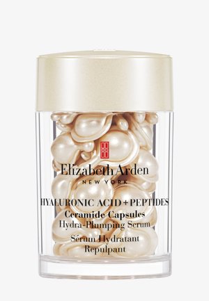 Läpinäkyvä purkki, jossa helmimäisen väriset seerumikapselit, joissa lukee Elizabeth Arden Hyaluronic Acid + Peptides Ceramide Capsules Hydra-Plumping Serum.