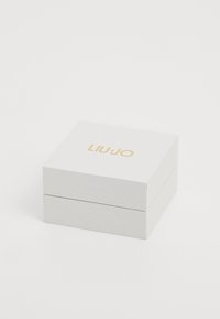 White textured square jewelry box with gold "LIU·JO" logo centered on the lid, closed against a plain white background.
