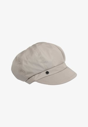 Lichtbeige pet gemaakt van zacht stof met een ronde vorm, voorzien van een gebogen rand en een decoratieve zwarte knop aan de voorkant.