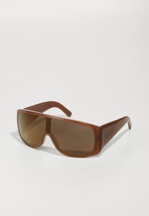 Brown oversized sunglasses with gradient brown lenses, rectangular shape, and smooth plastic frame. Accents include engraved detailing on arms.