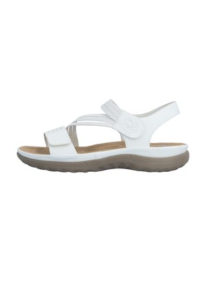 White open-toe sandal with adjustable straps, cushioned brown sole, and textured rubber outsole for grip, designed for casual wear.
