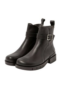 Botas de tobillo de cuero negro con punta redondeada, detalle de correa y hebilla, suela de goma texturizada y tiradores para ponerlas fácilmente.
