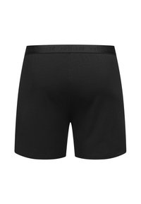 Zwarte katoenen boxershorts met een zachte, elastische tailleband met het merklogo. Soepele textuur, lengte tot halverwege de dij en een getailleerde pasvorm.